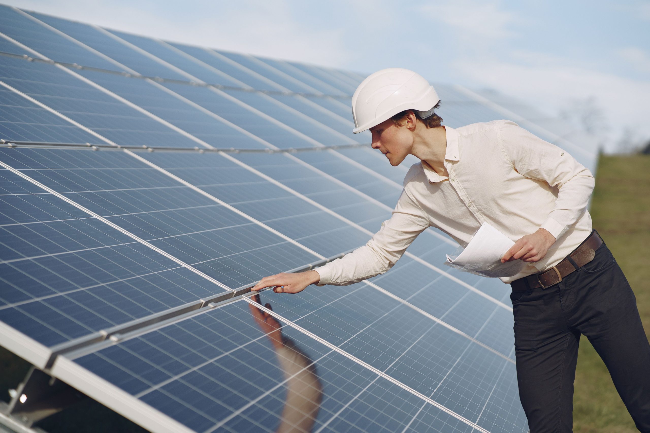 businessman-white-helmet-near-solar-battery